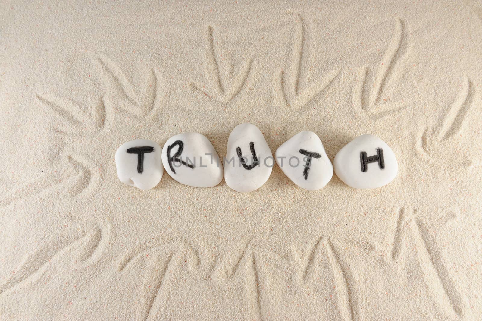 Truth word on group of stones on the sand