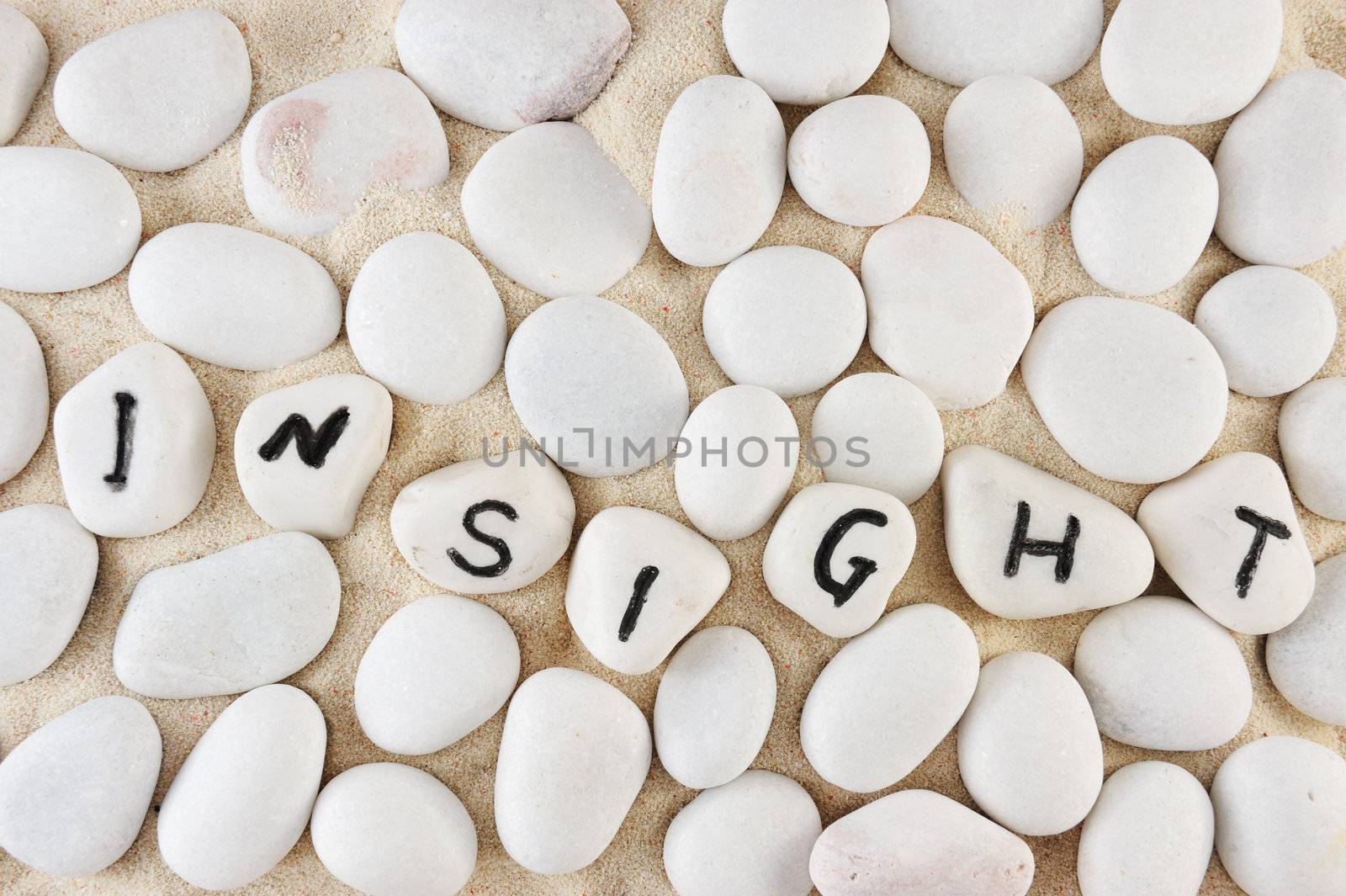 Insight word among group of stones on the sand