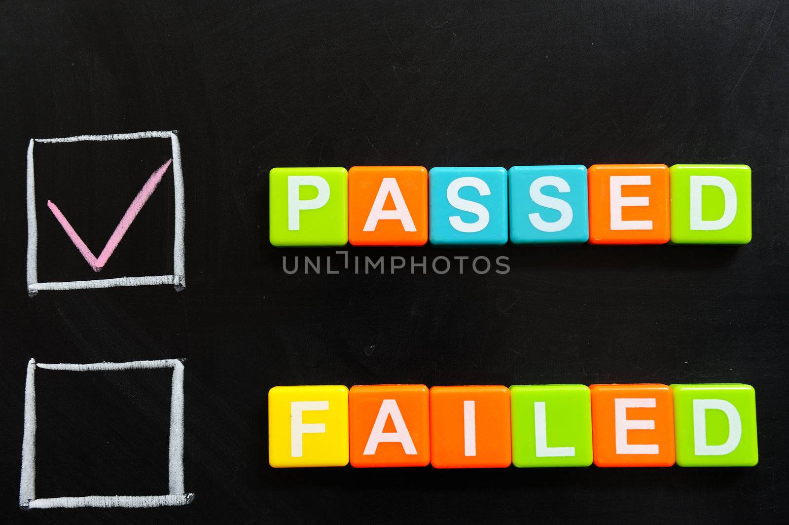 Passed or failed words made of blocks on blackboard