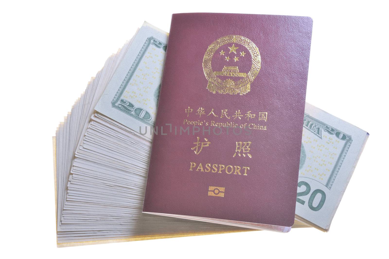Chinese passport and a pile of US Dollars isolated on white