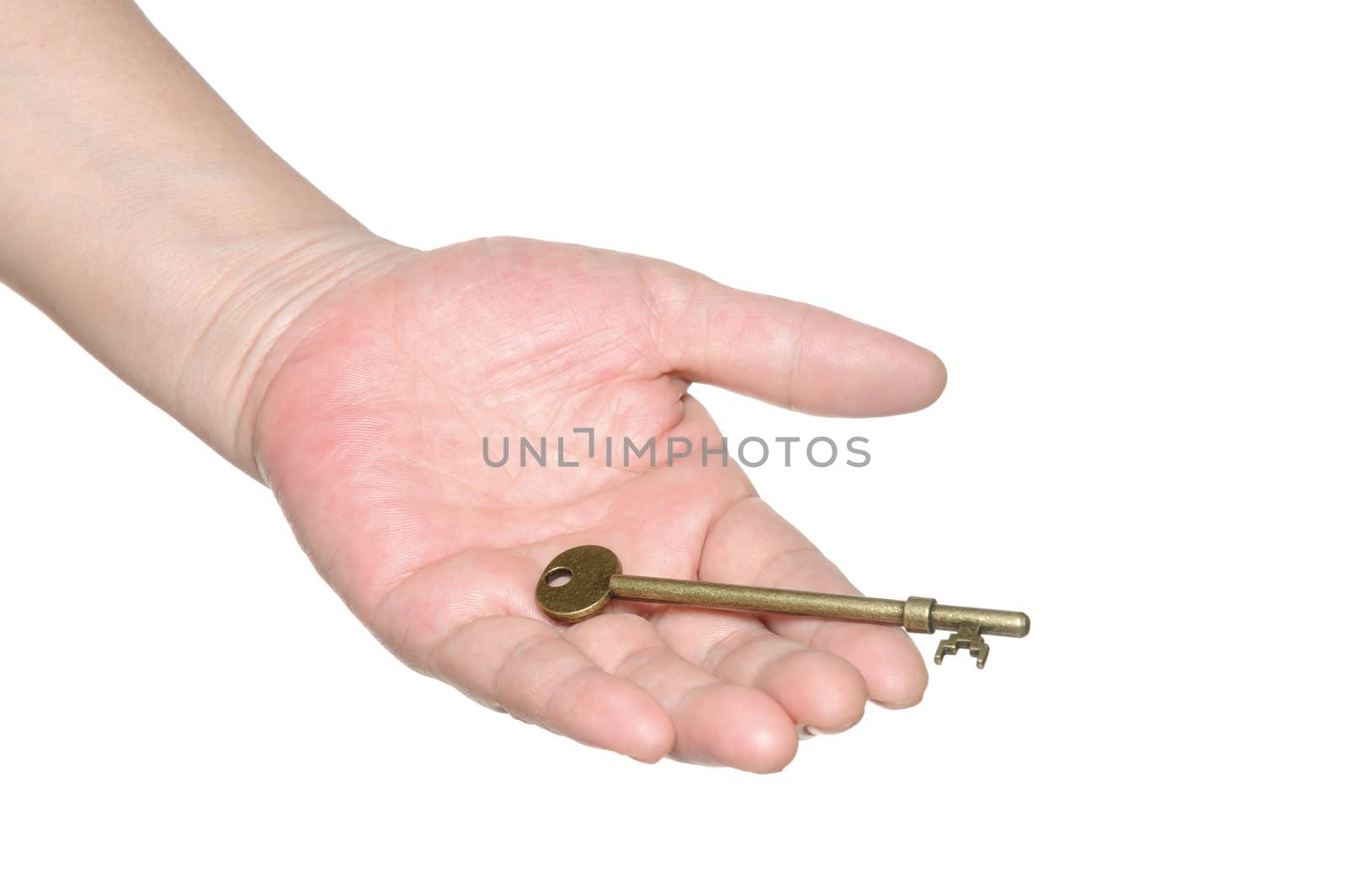 Hand passing an old key isolated on white background