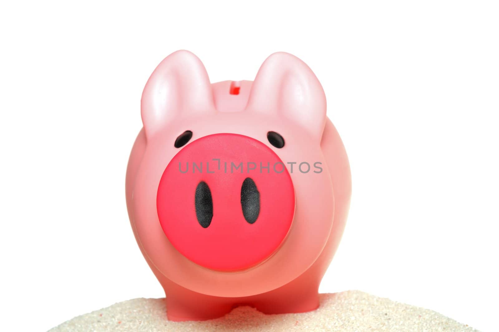 Piggy bank on sand isolated on white
