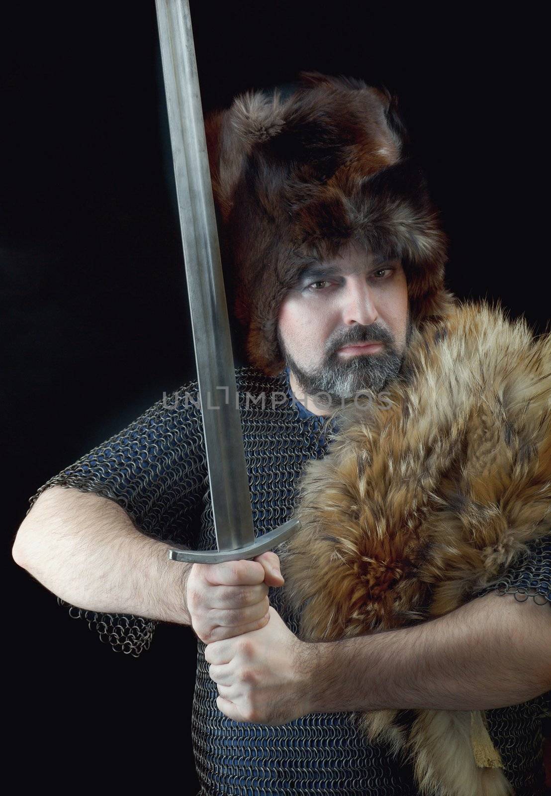 	Cimmerian.barbarian  Warrior.Medieval knight in the armor with the sword.
