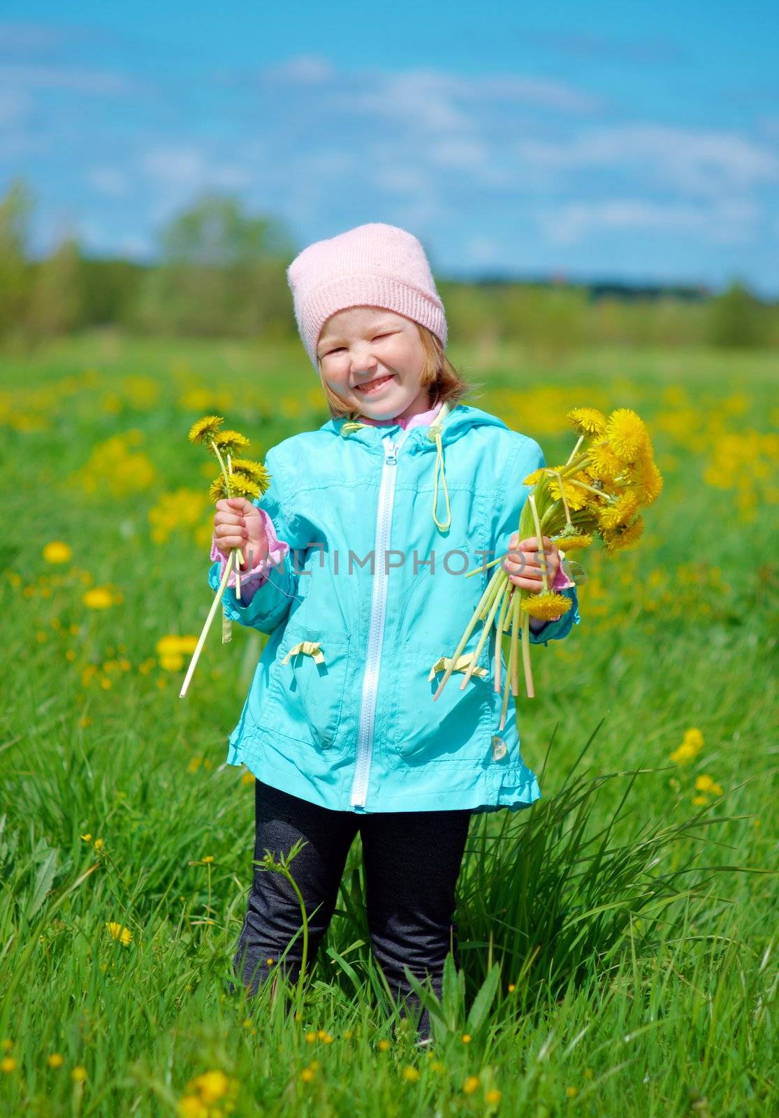 small girl  on meadow with dandelion