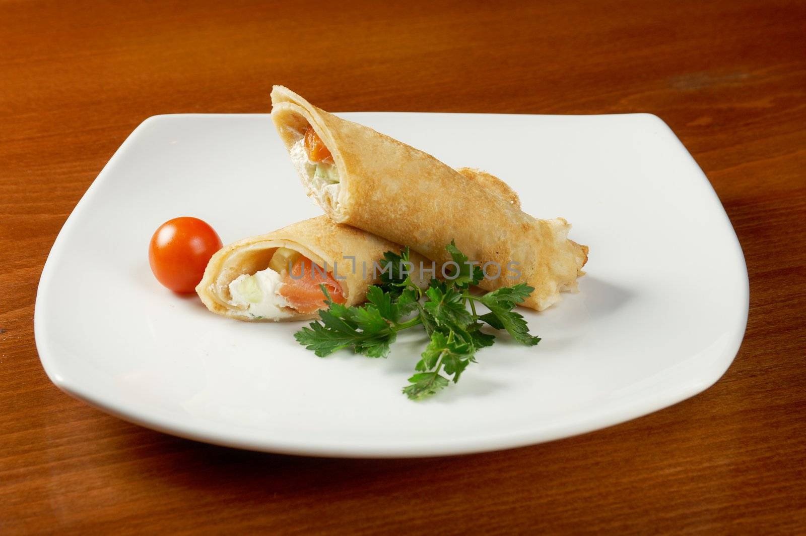 rolled pancakes stuffed chicken. Shallow depth-of-field.