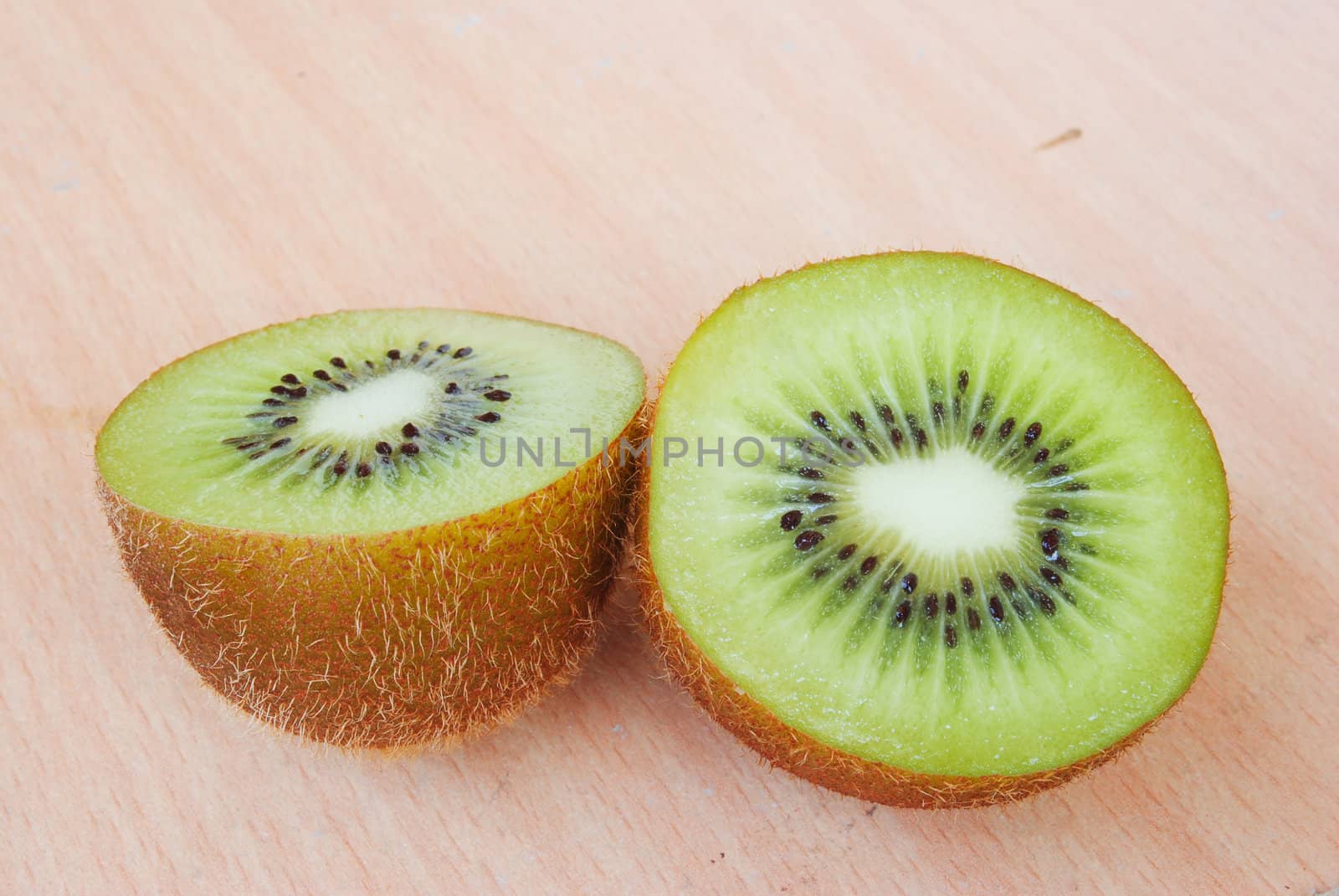 Fresh kiwis on wooden ground