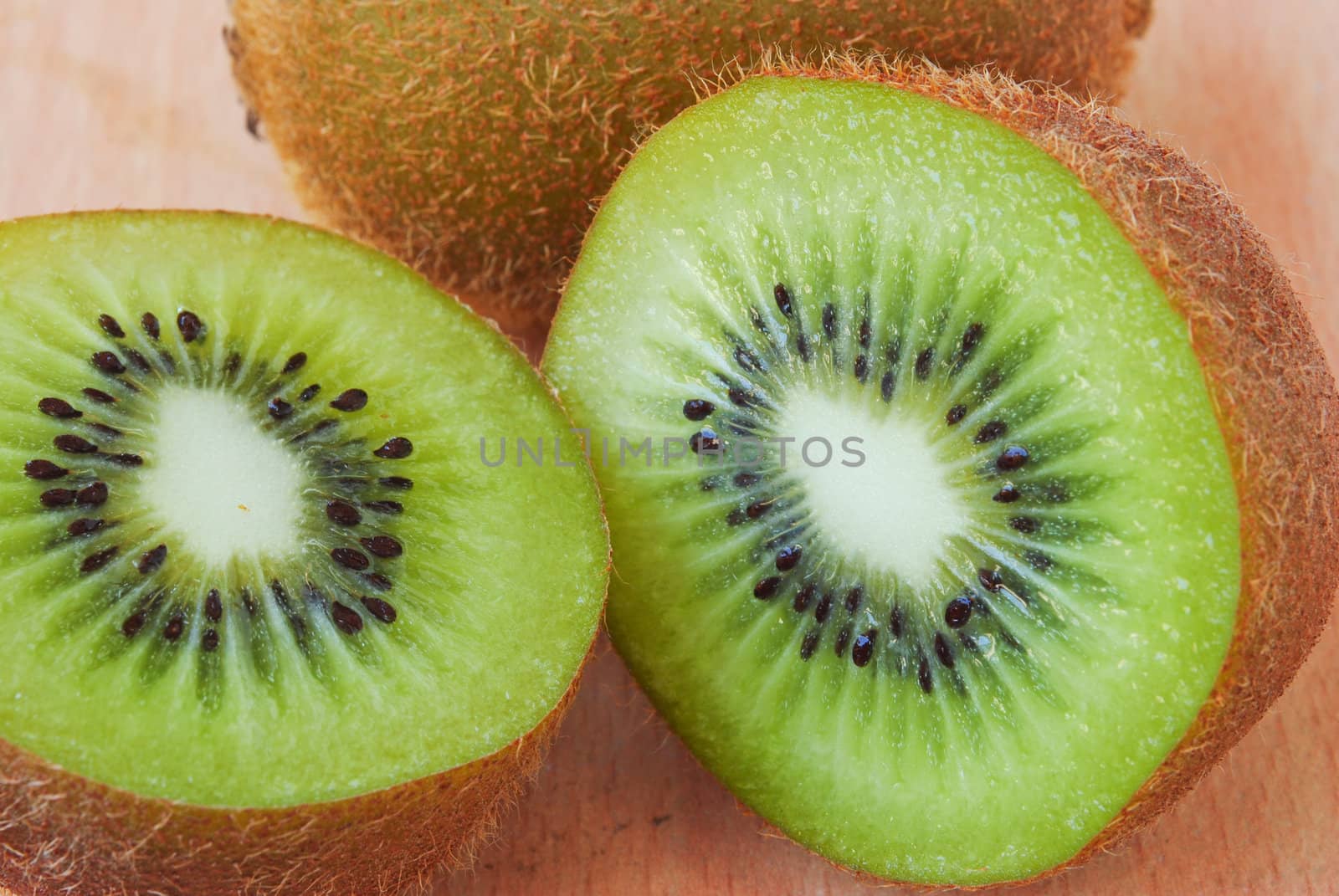 Fresh kiwis on wooden ground