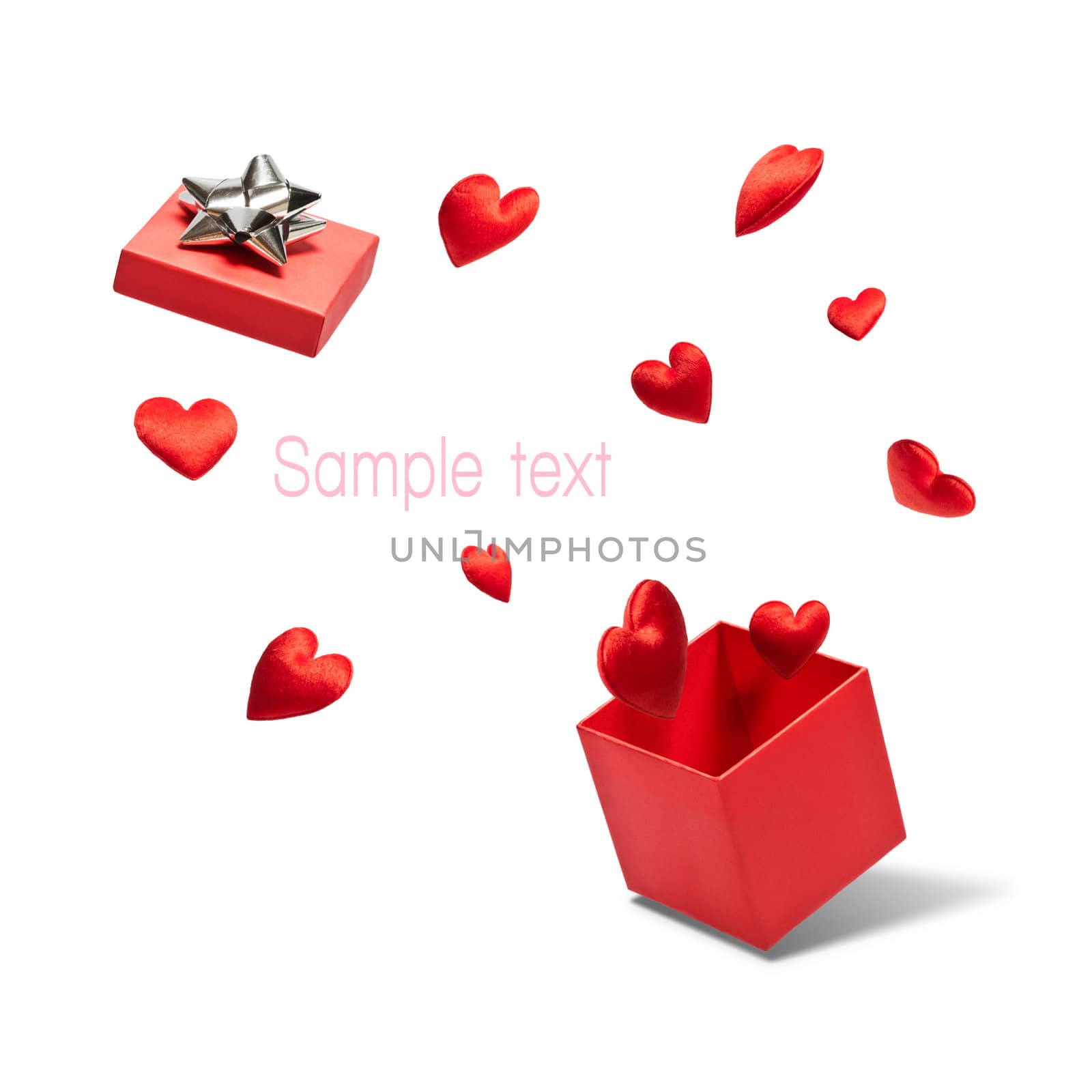 Opened gift box with flying hearts over white background
