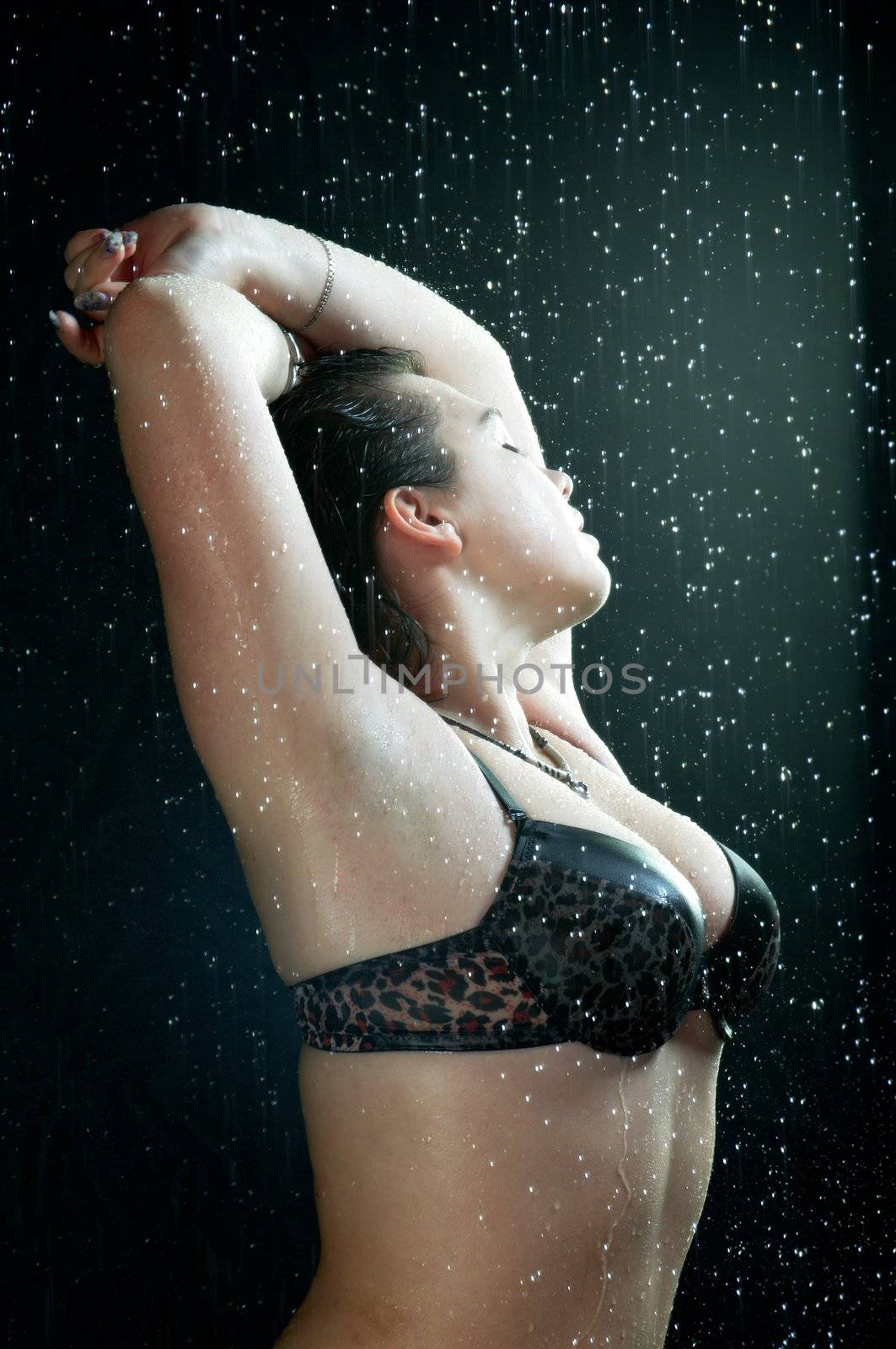 Young sexy woman water studio portrait.