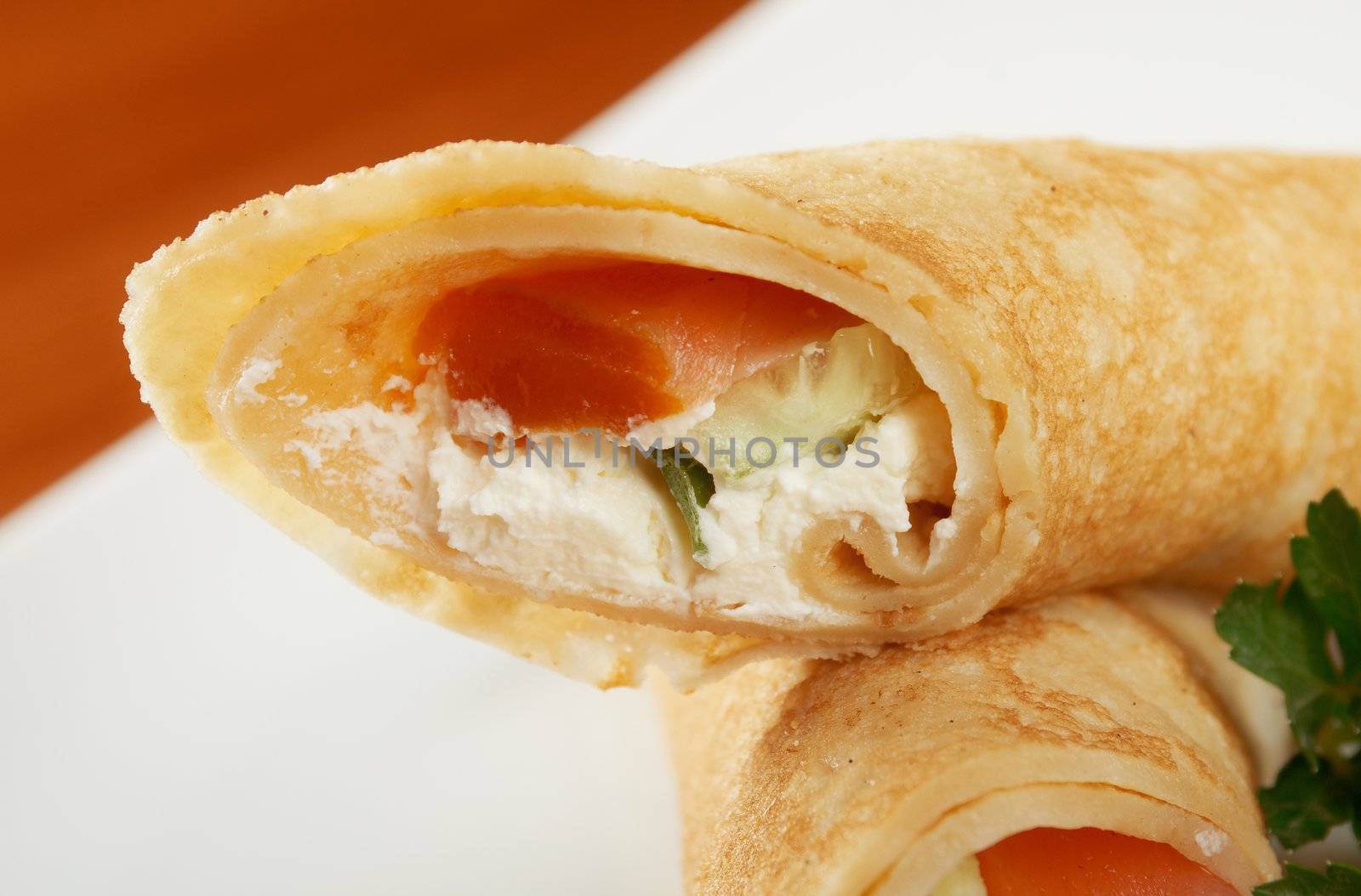 rolled pancakes stuffed chicken. Shallow depth-of-field.