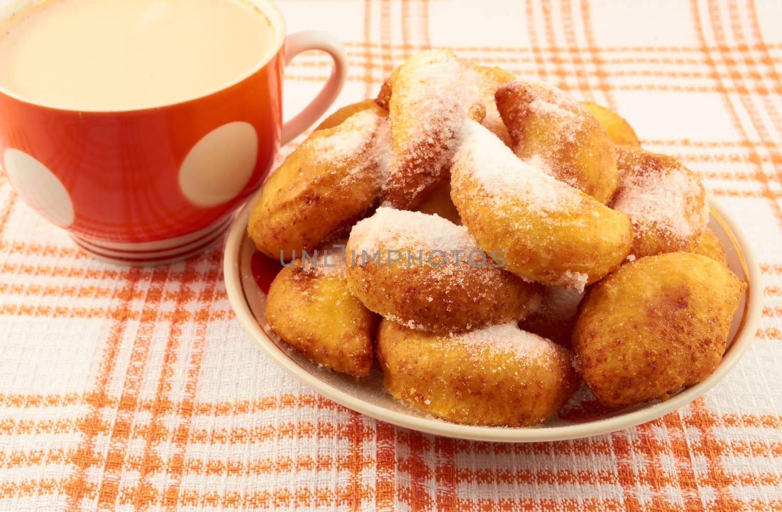  Sweet cheese donuts sprinkled with powdered sugar on a plate