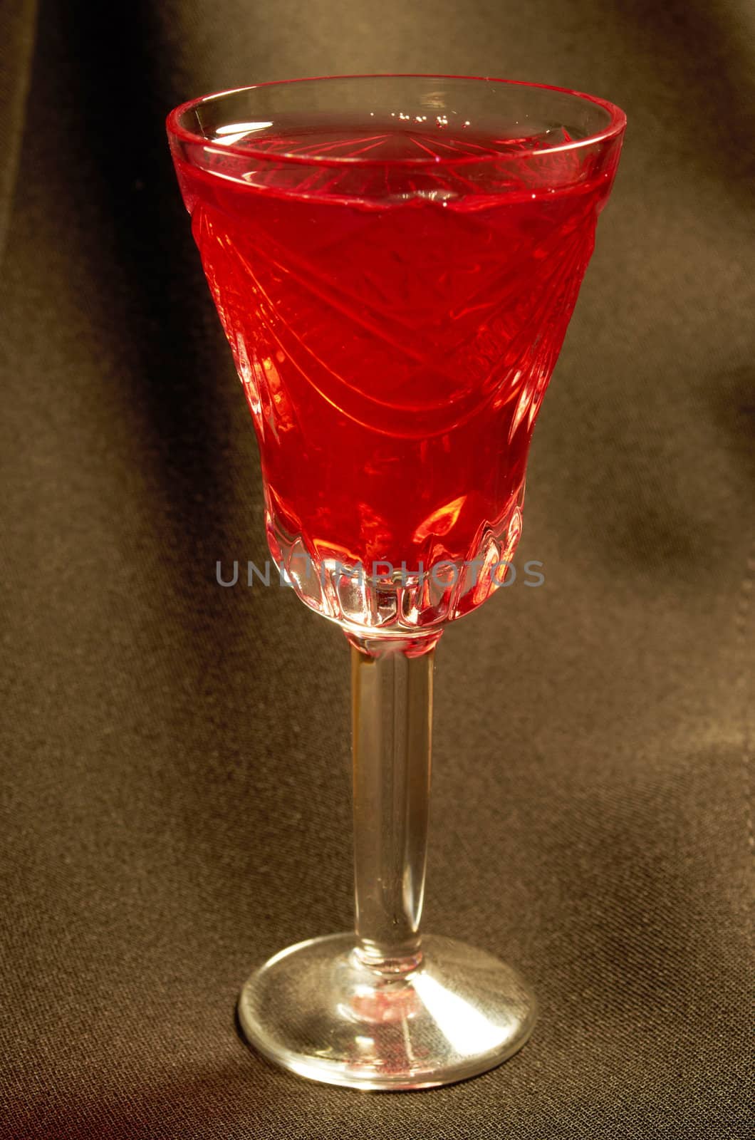 Crystal glass filled with red wine on a black background