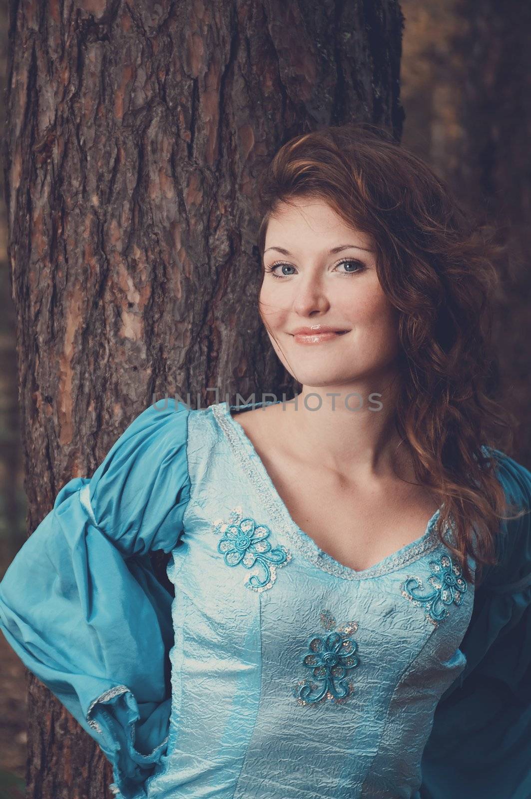 Very beautiful girl in medieval dress in autumn wood