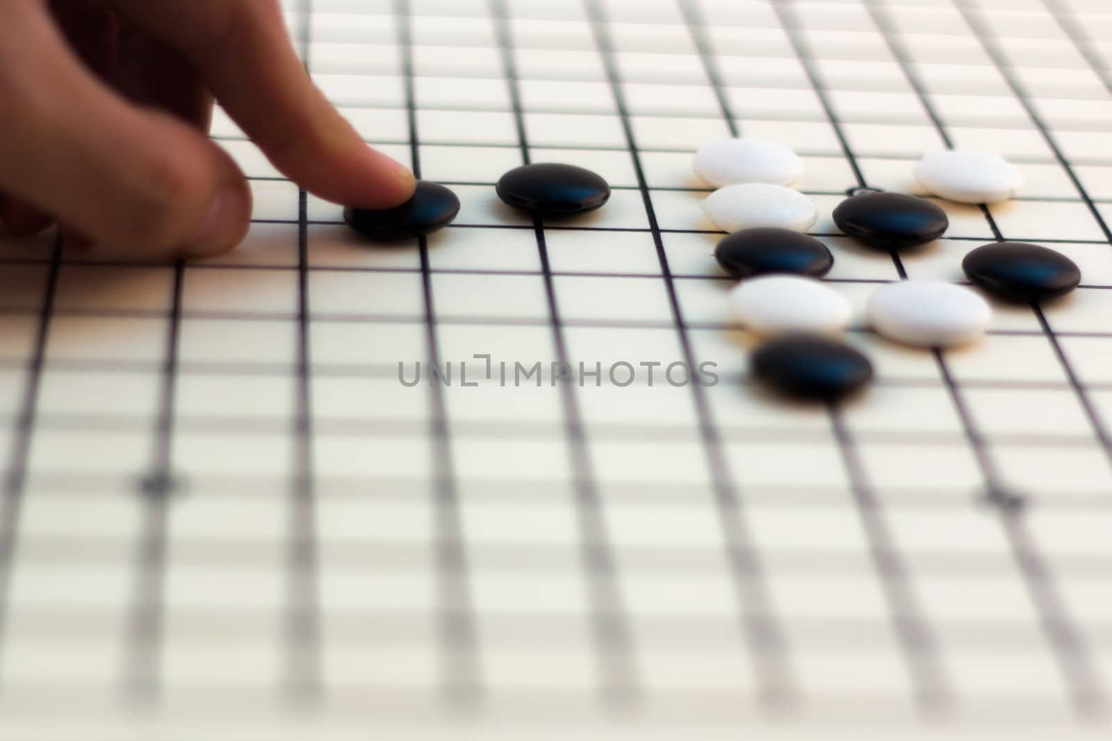 Hand making move on Traditional Chinese Board Game - Go
