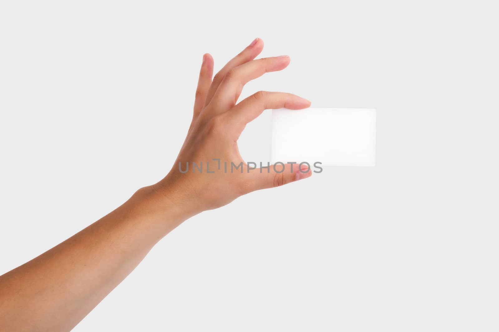 Female Hand Holding a Blank Business Card. Isolated on light grey background.