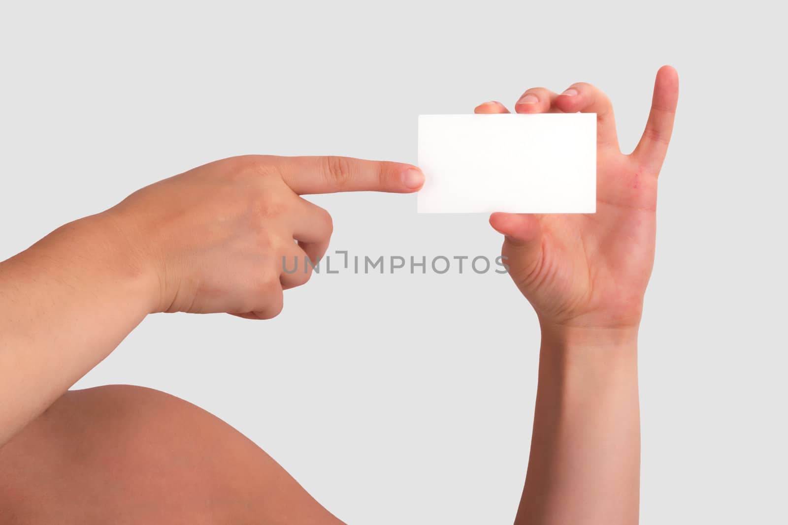 Woman Holding Blank Business Card and pointing it with her other hand.