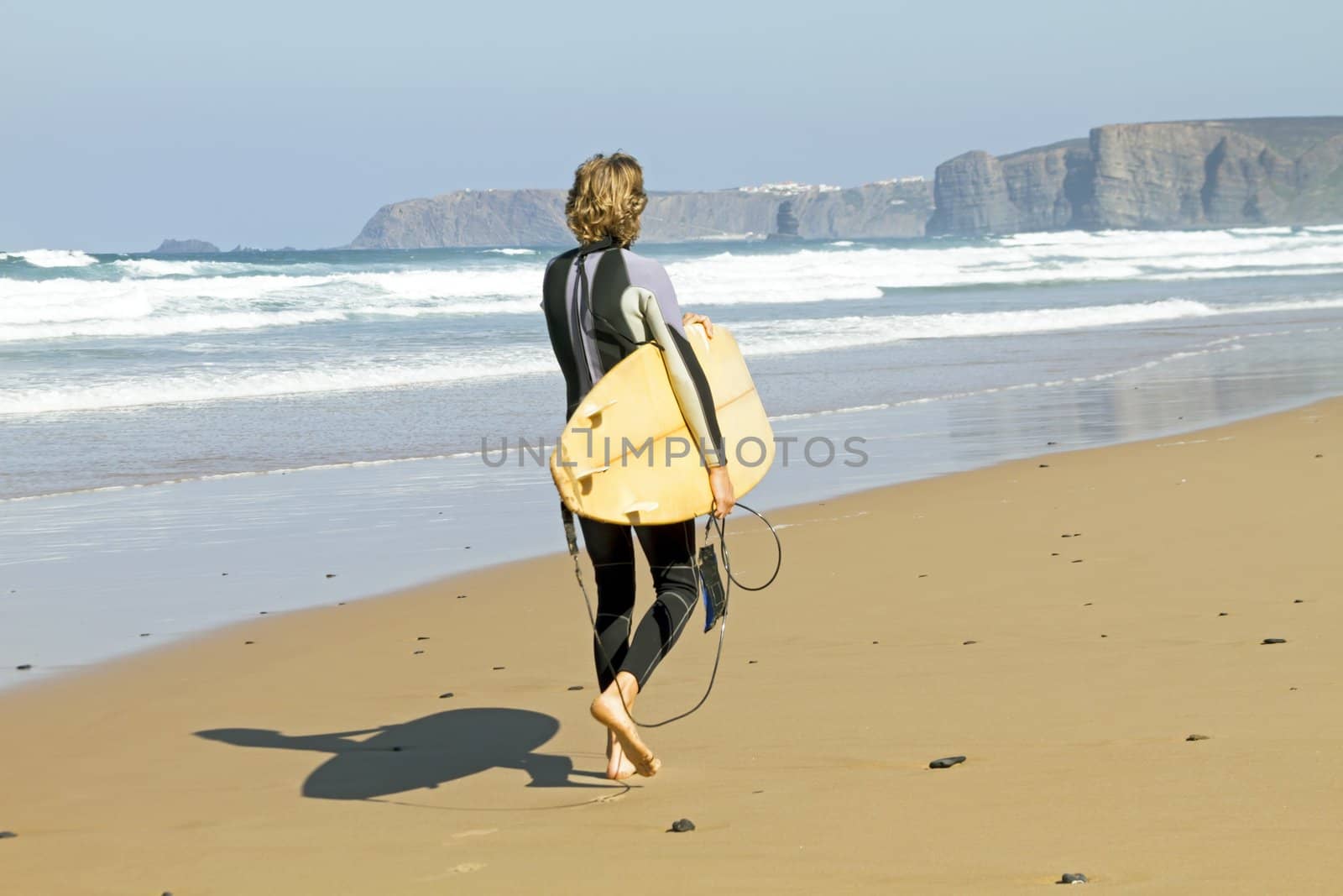 Surfer with his surfboard at the beach