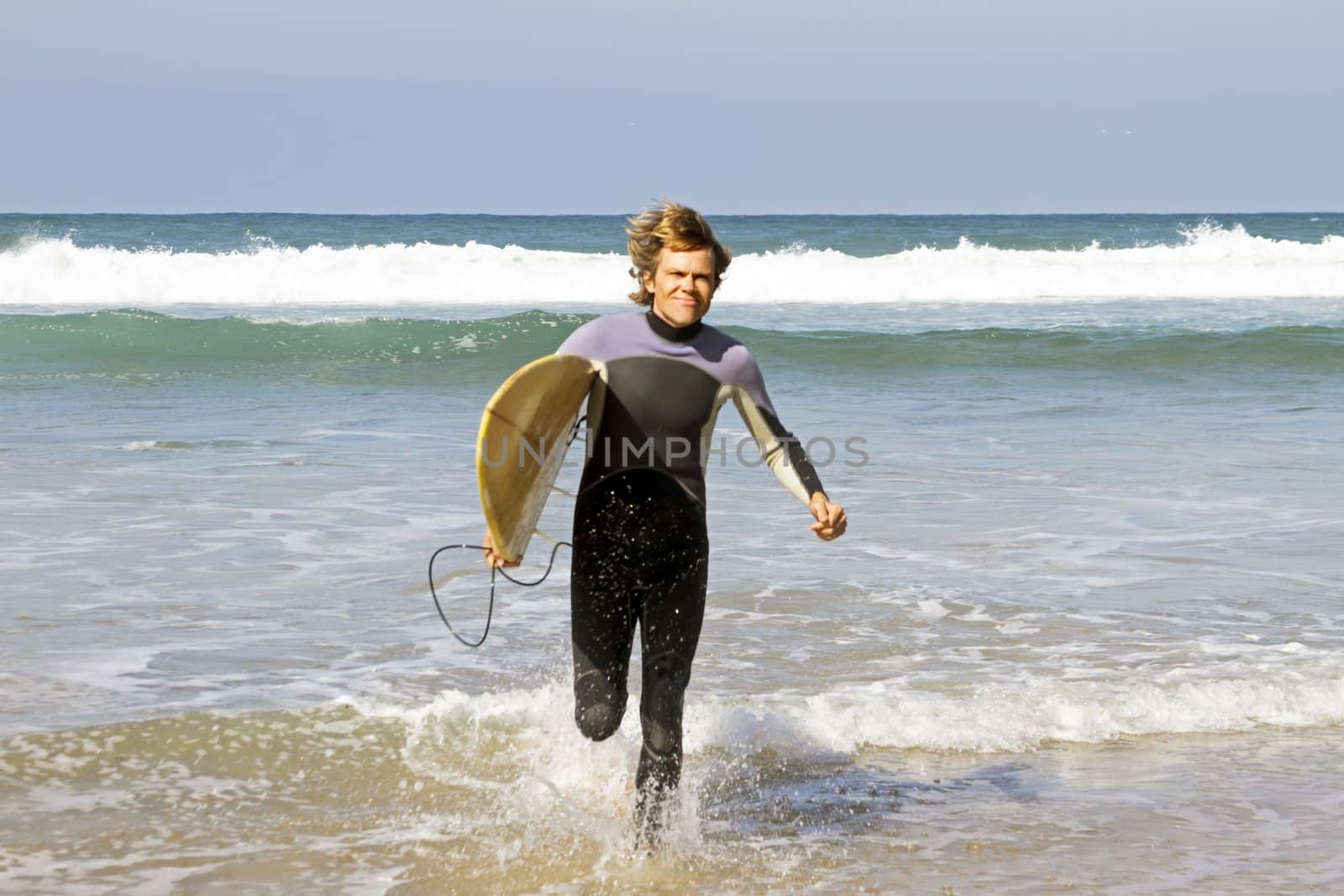 Surfer with his surfboard at the beach