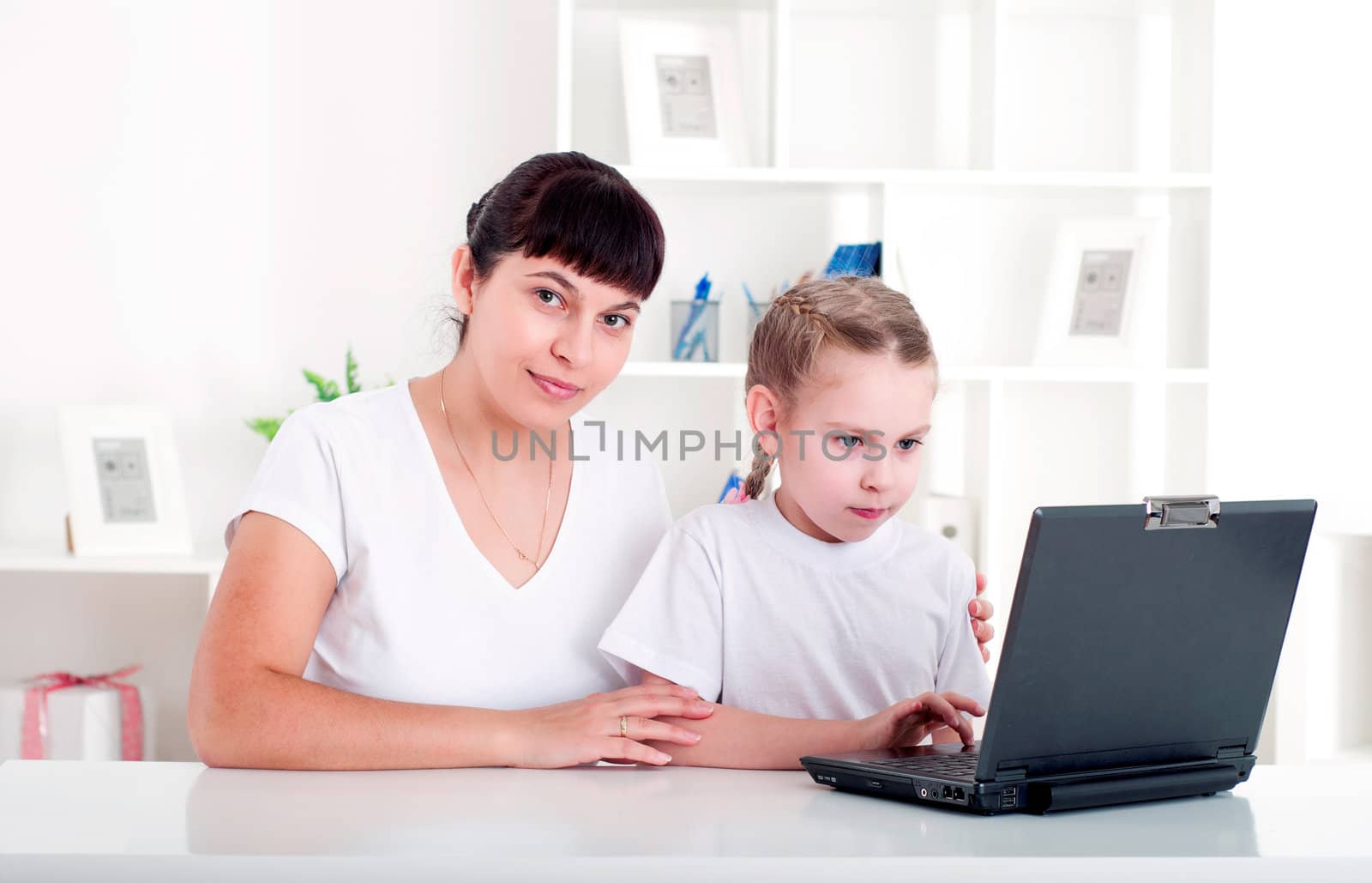 Mom and daughter are working together for a laptop by adam121