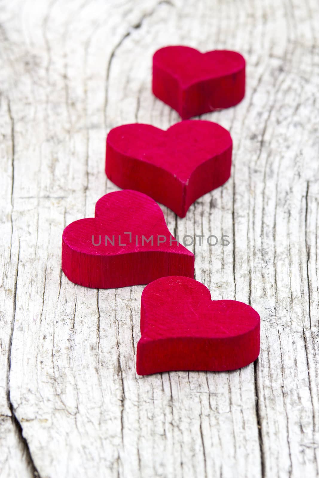 red hearts on old wooden background