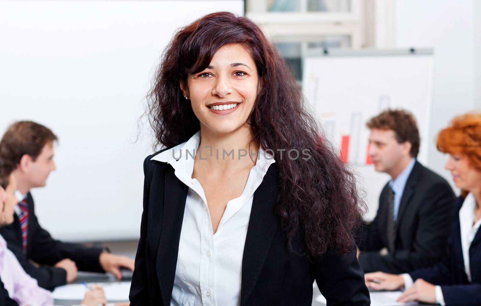 professional successful business woman in office smiling by juniart