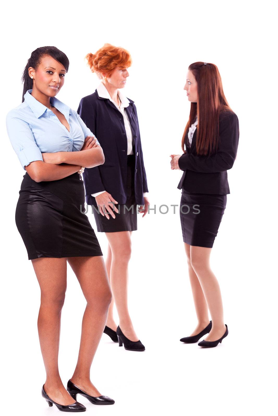 happy young african business woman and female team in background isolated on white background
