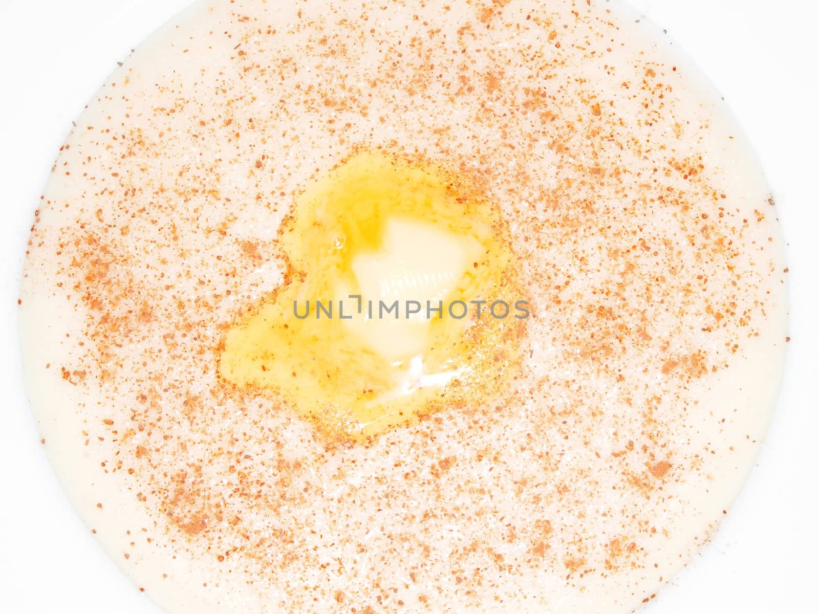 Porridge in a deep bowl with butter eye, cinnamon and sugar