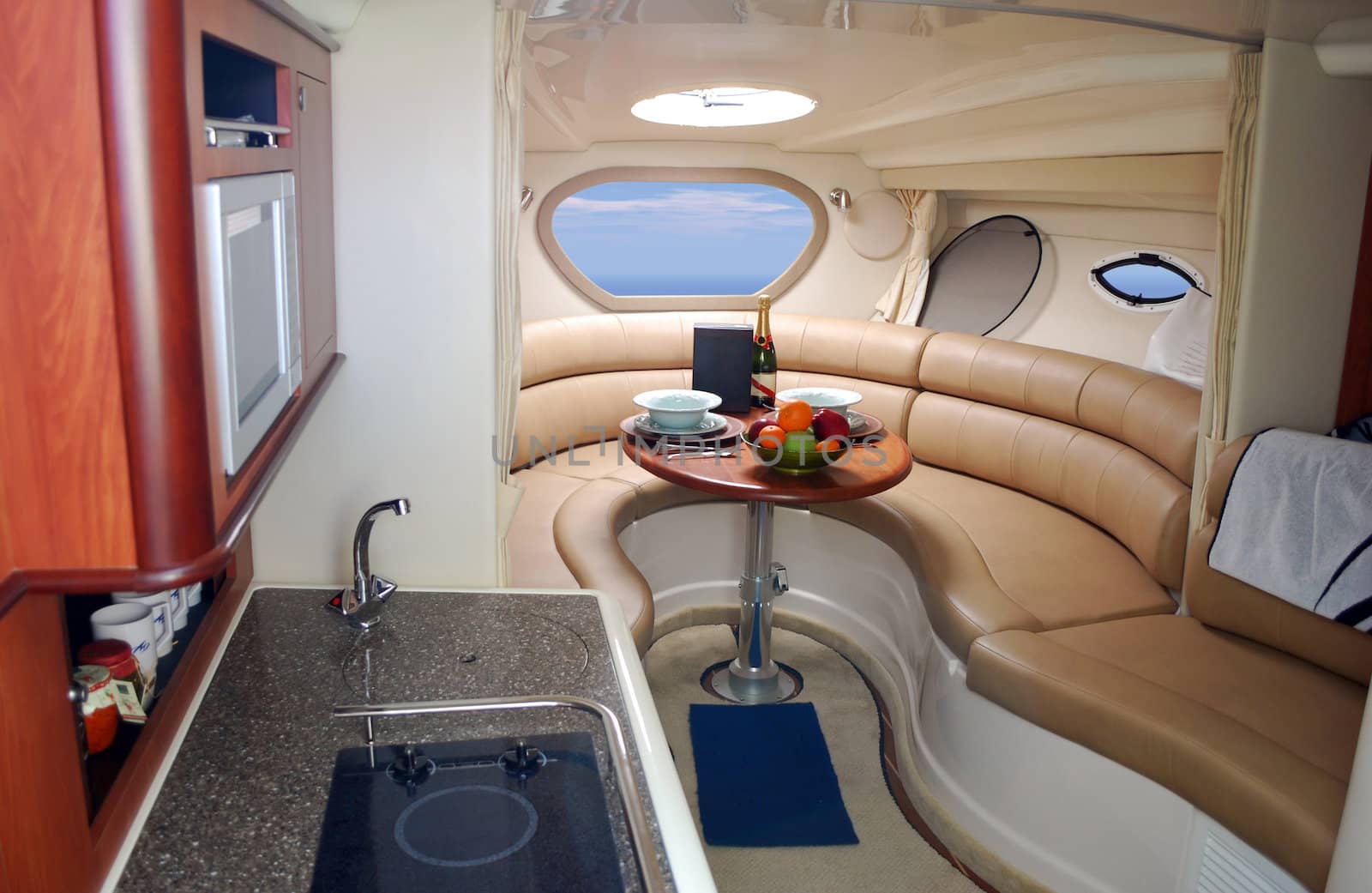 New luxury yacht interior with champagne and fruits on table