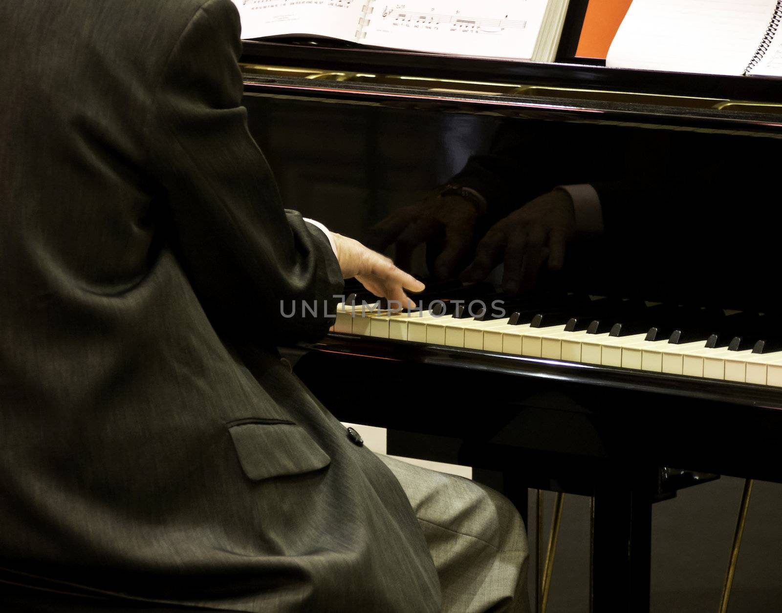 Close up of male hands playing piano.