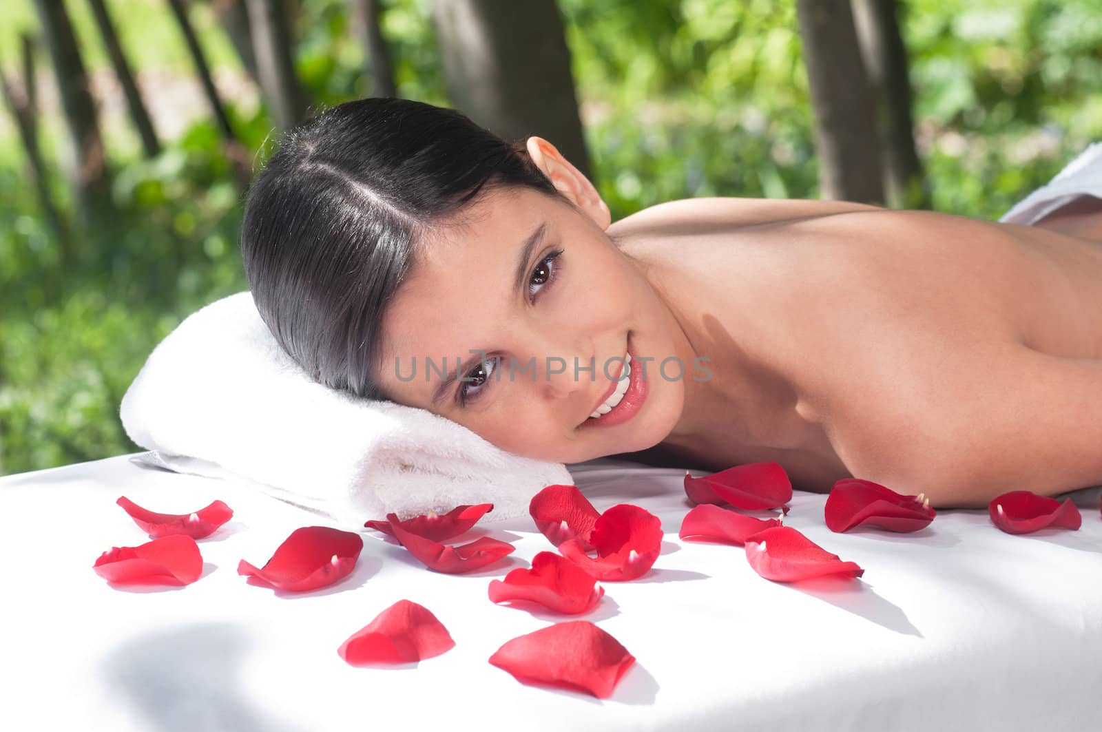 Portrait of woman on massage table by leaf