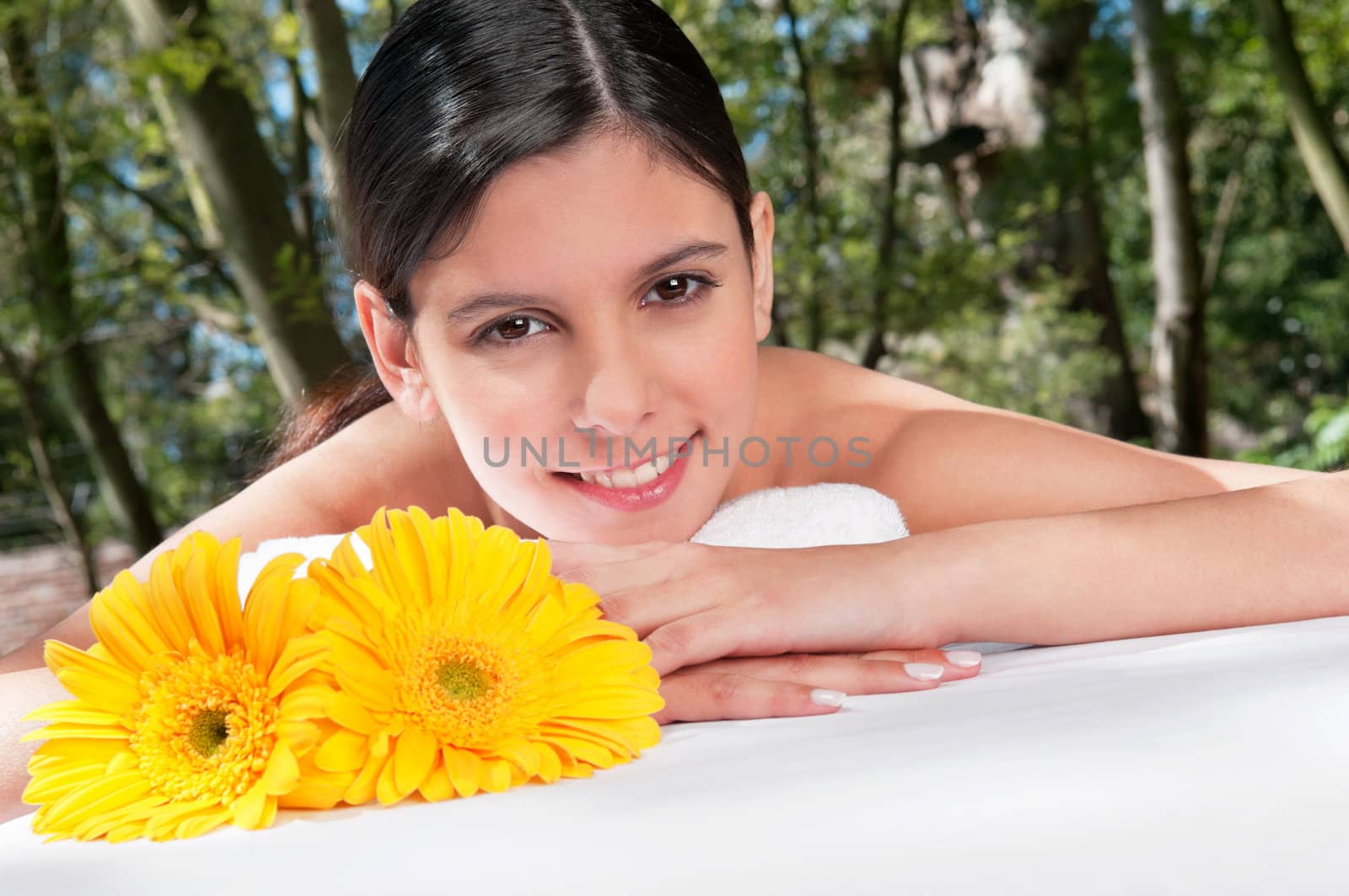 Beautiful young woman with flowers around by leaf