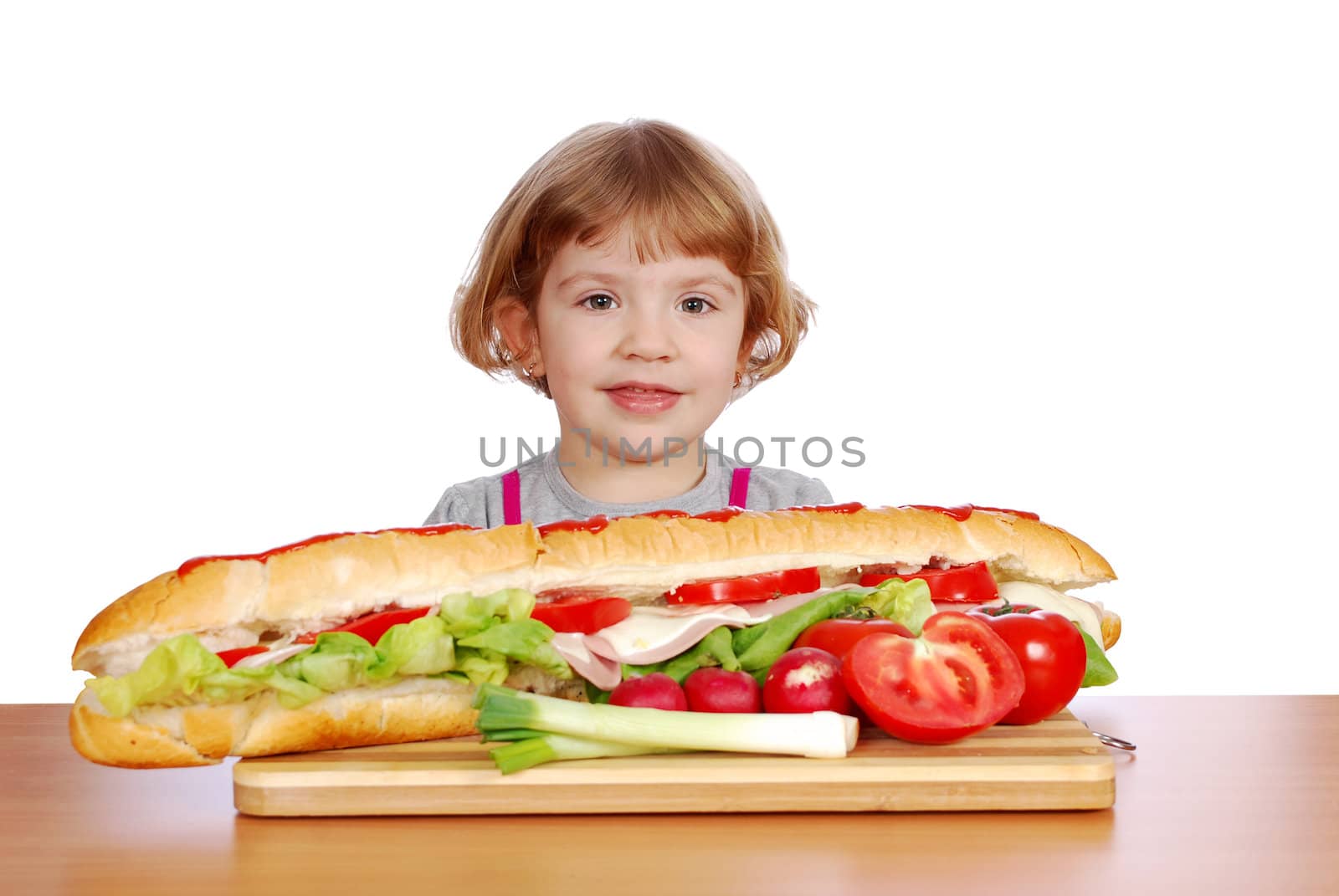 Beauty little girl with sandwiches and vegetables