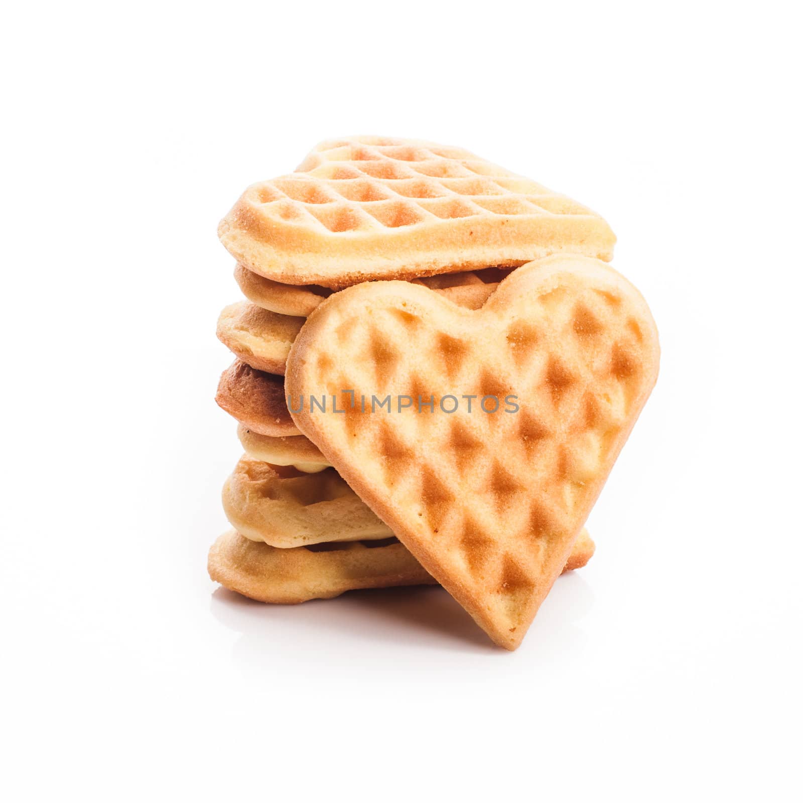 Stack of heart shaped waffles isolated on white background
