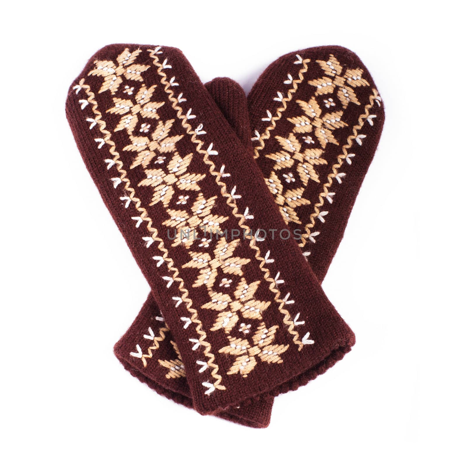 Brown woolen knitted mittens on white background