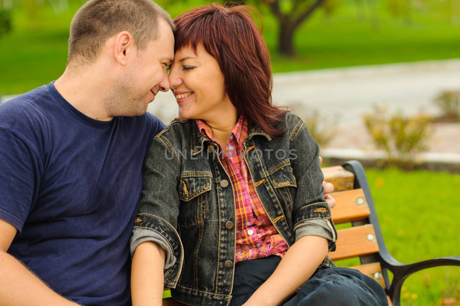 Good looking couple in love smiles each other outdoor