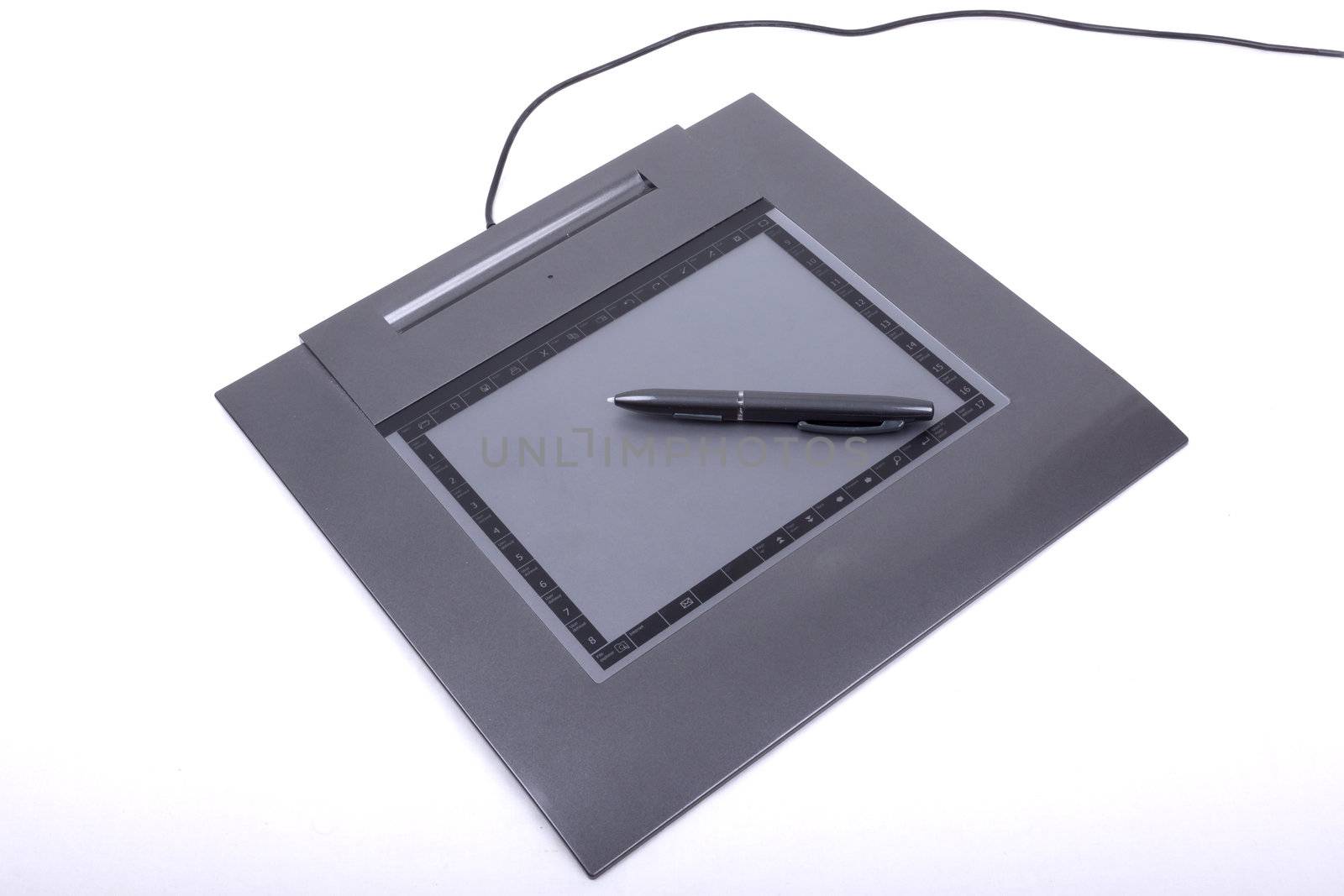 photo of graphic tablet with pen on a white background