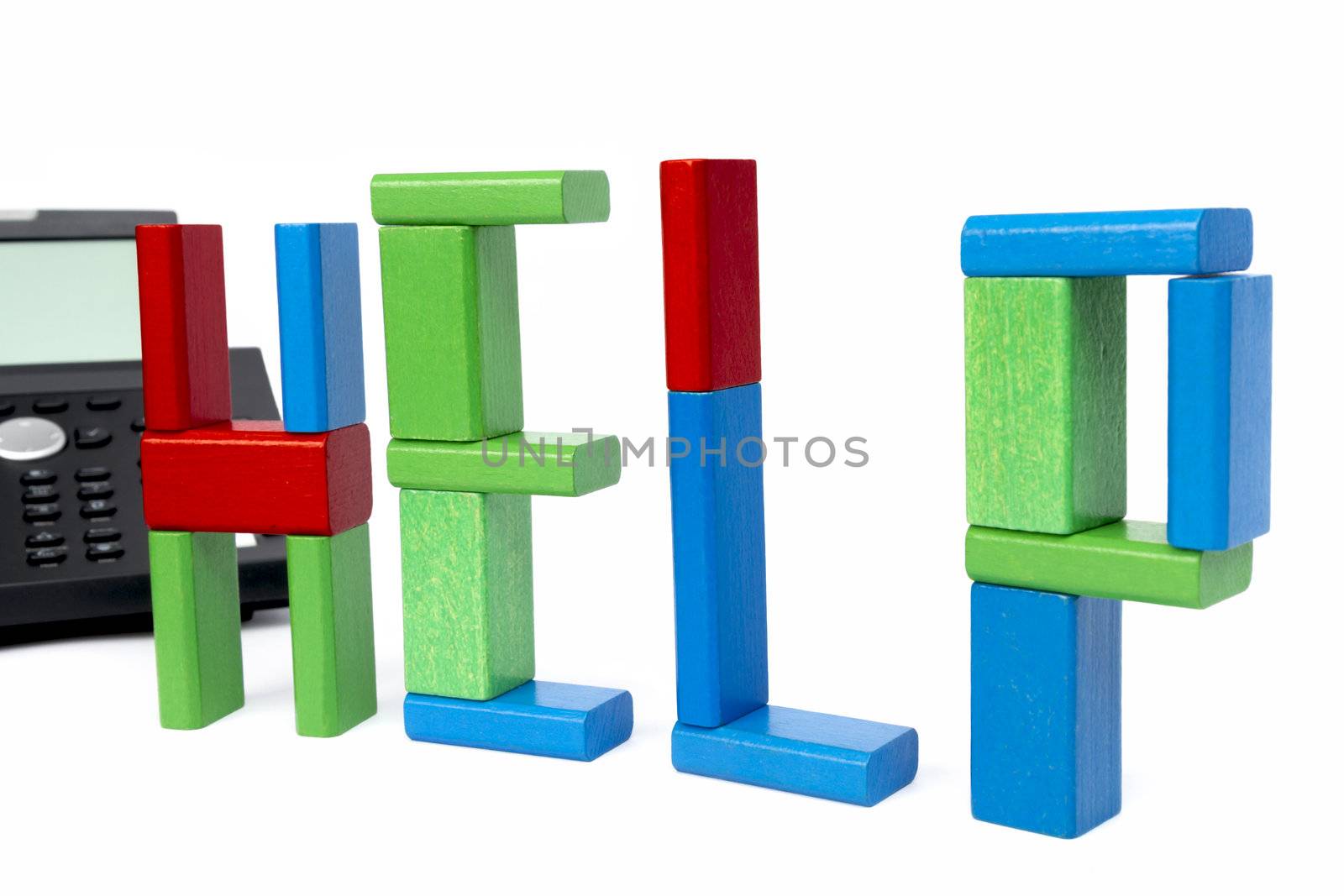 the word help made with toy bricks and a phone in background. isolated on white background