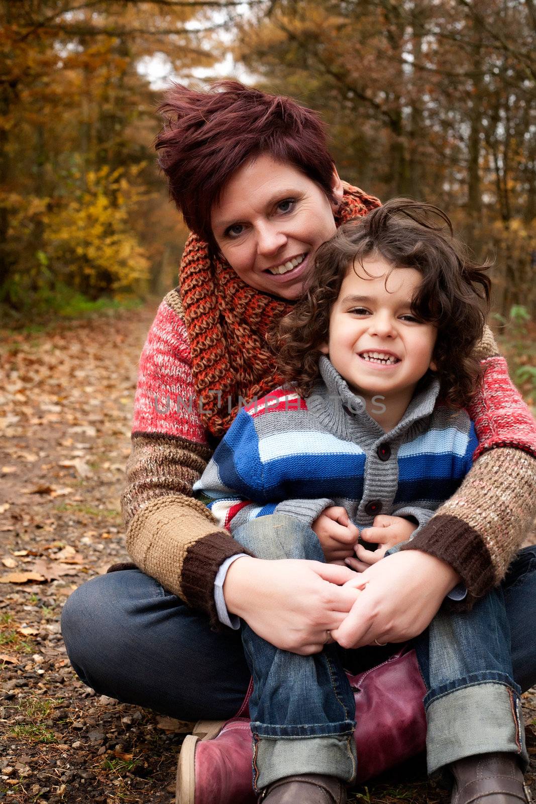 Happy mother and son in the forest