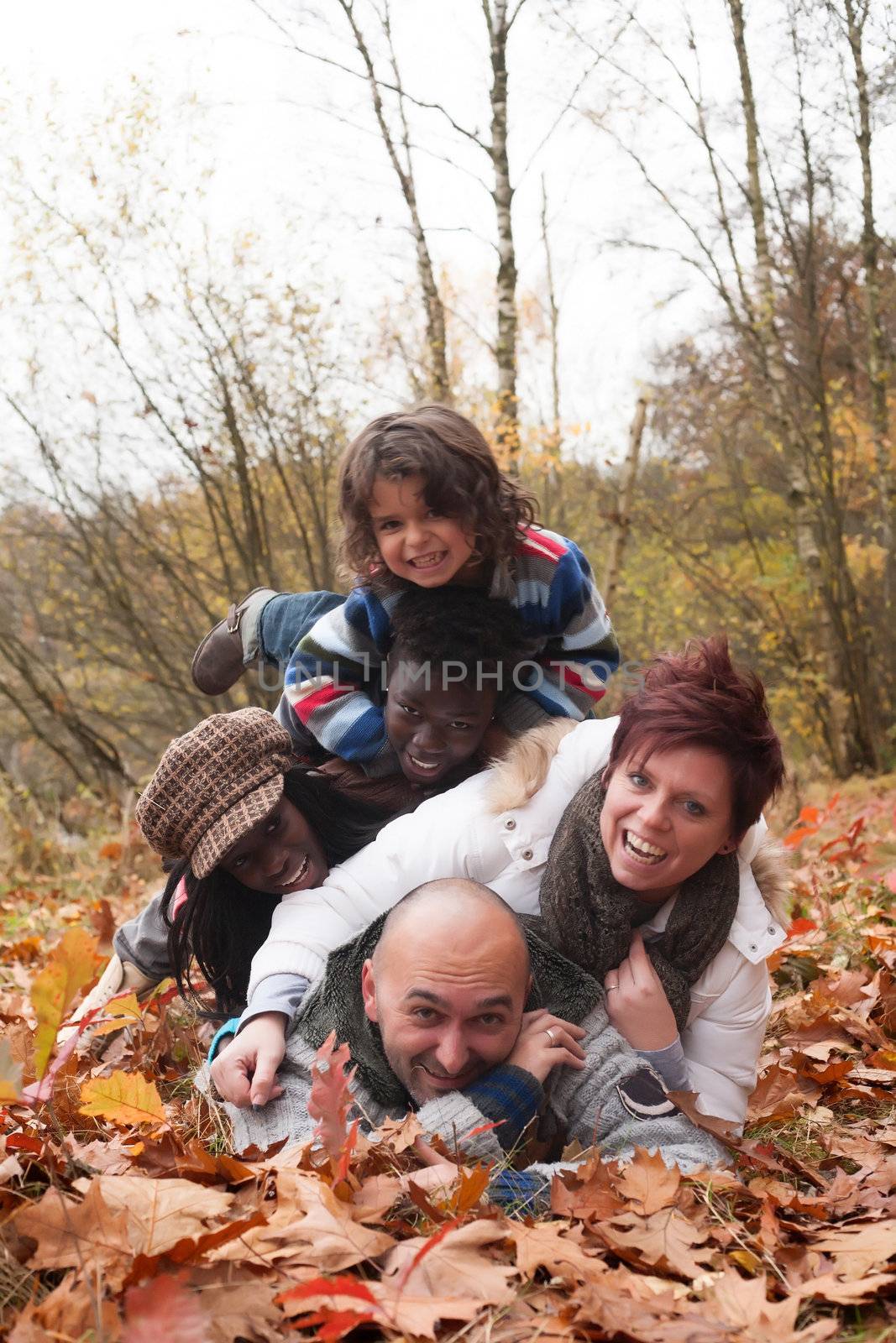 Happy family with foster children in the forest