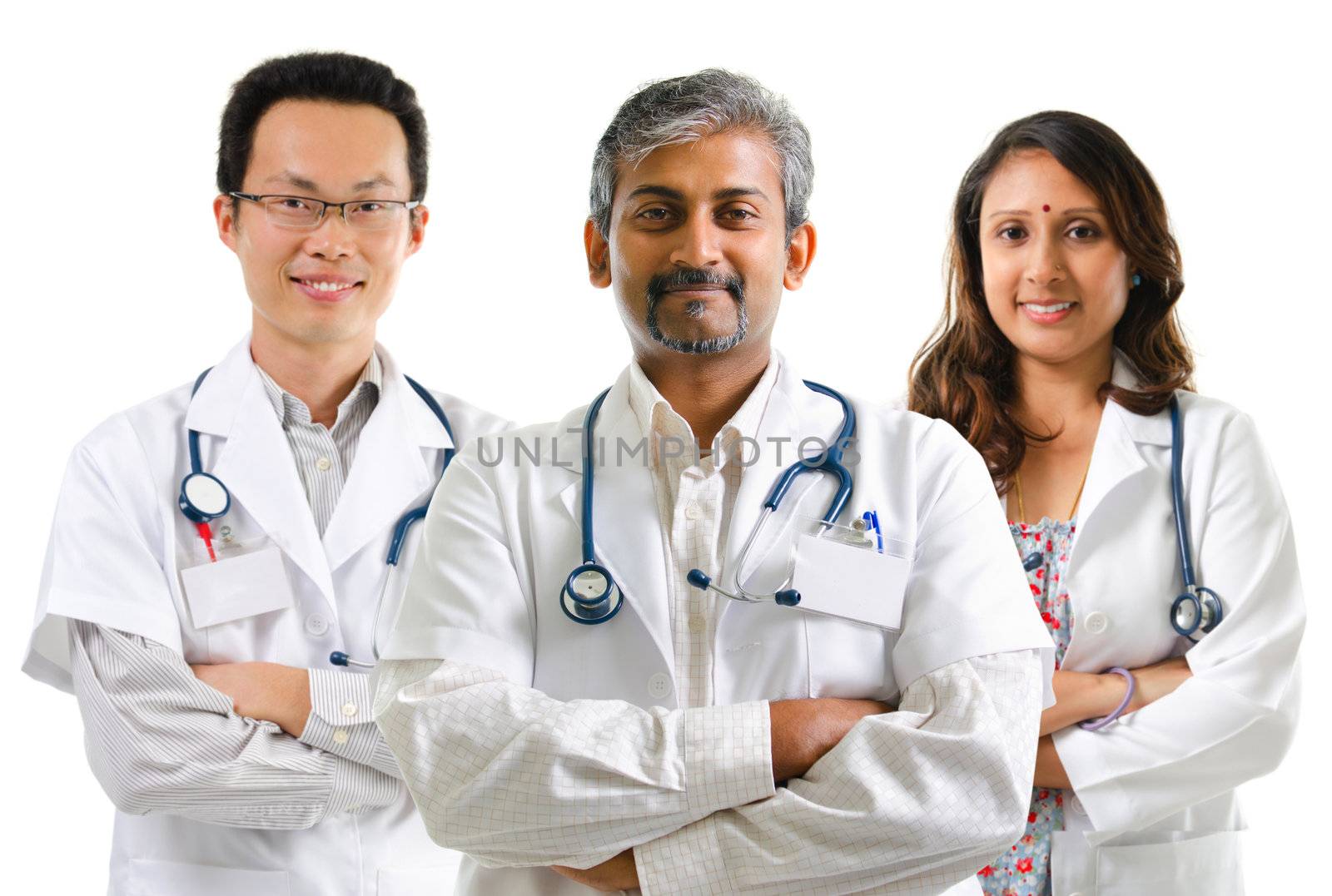 Multiracial doctors / medical team crossed arms standing on white background