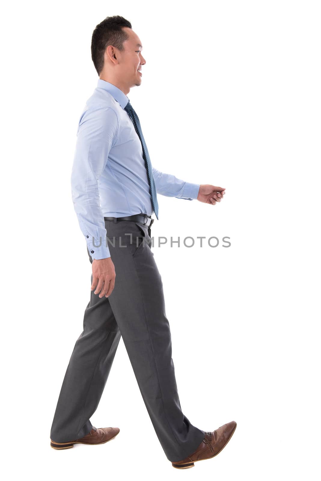 Side view full body Chinese Asian male walking looking forward isolated on white background
