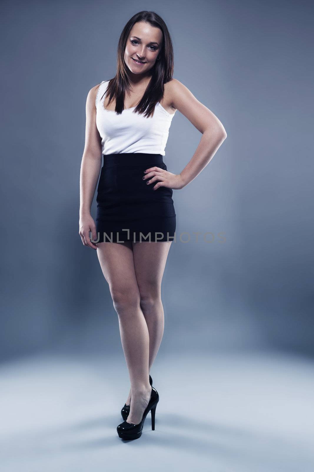 teenager with a black skirt on gray background