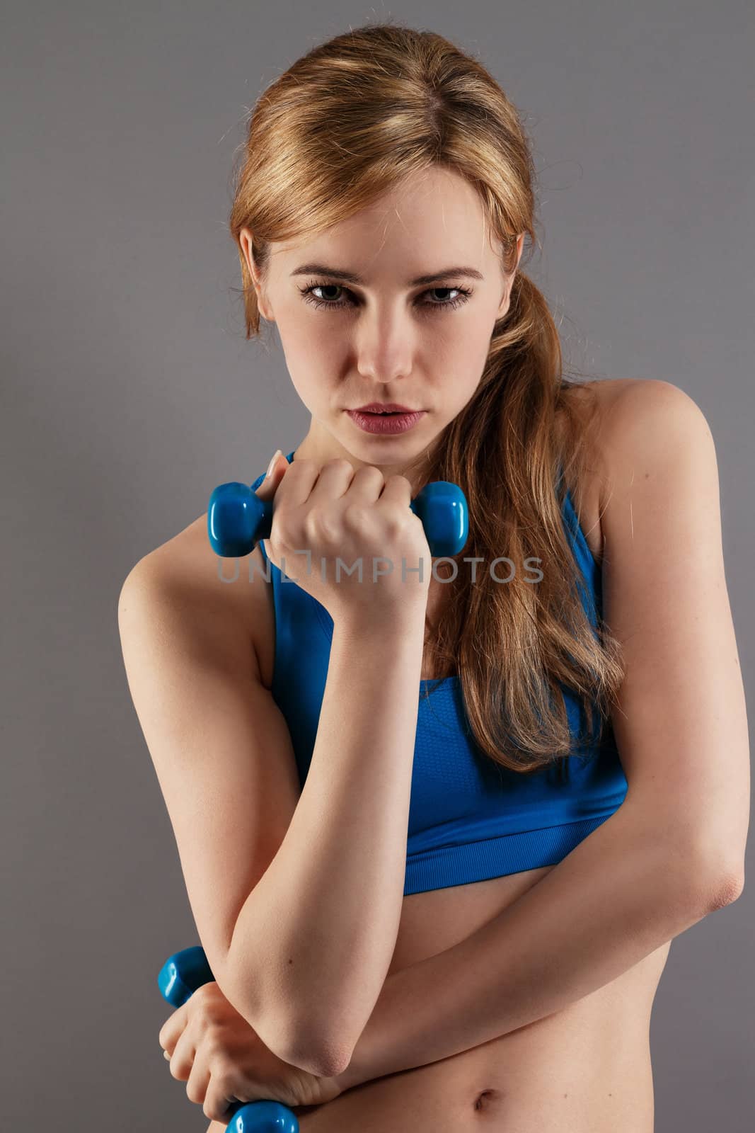 pretty fitness woman with blue dumbbells by RobStark