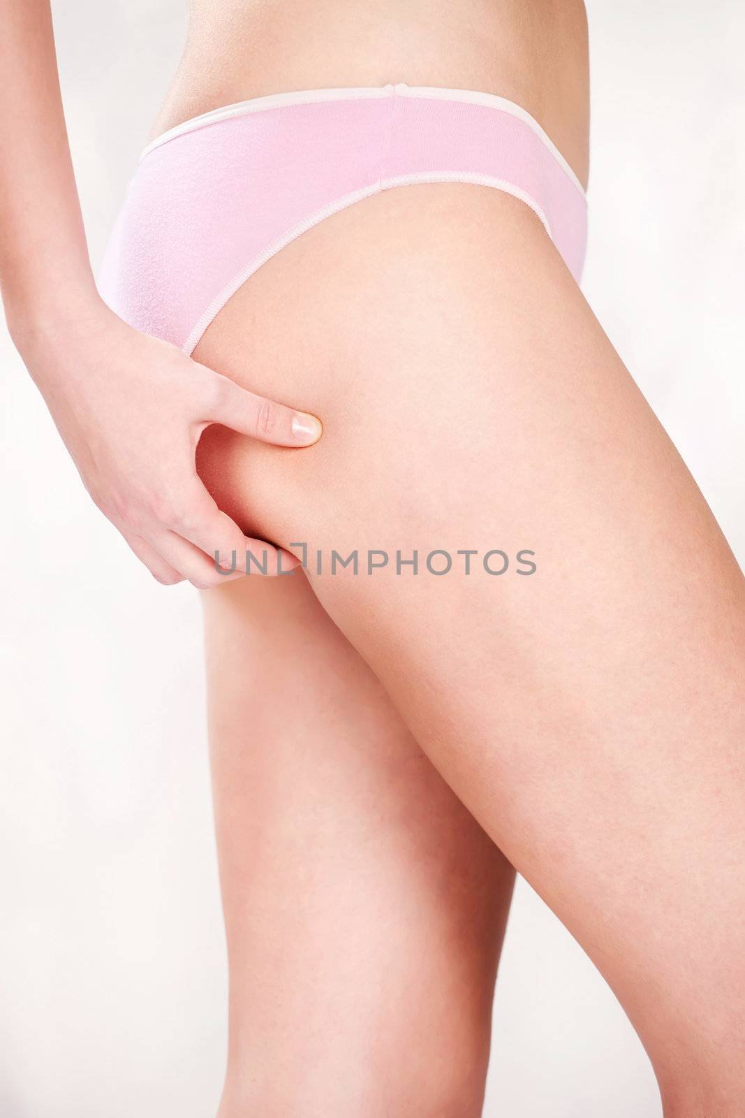 Woman pinching leg for skin fold test 