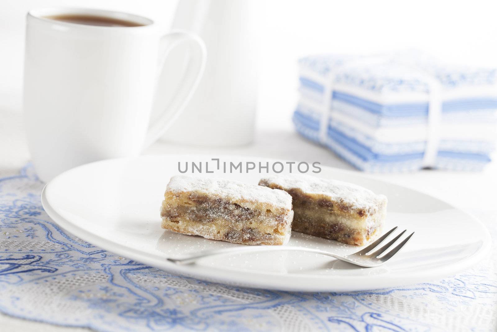 Sweet cakes with powdered sugar served with tea.