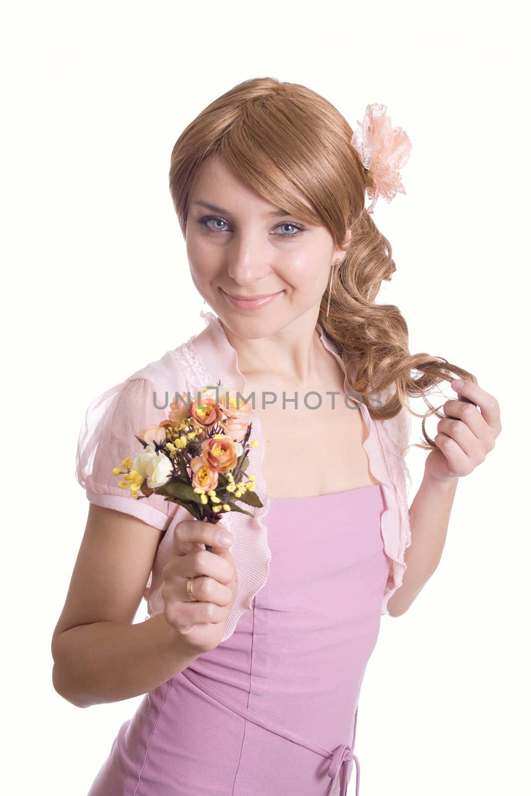 Beautiful woman in a pink dress with a bouquet of flowers
