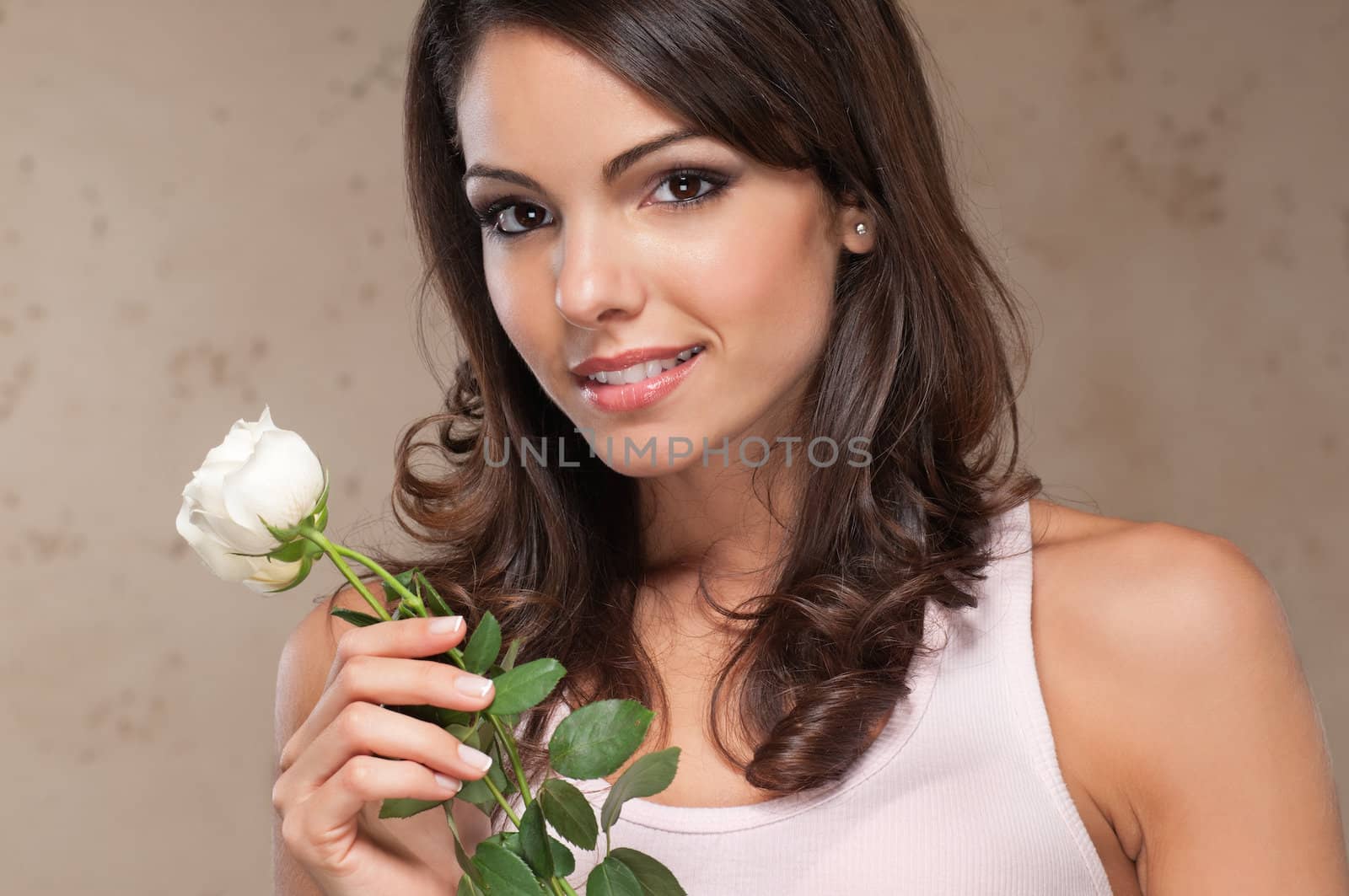 Close-up portrait of beautiful woman holding flowers and smiling