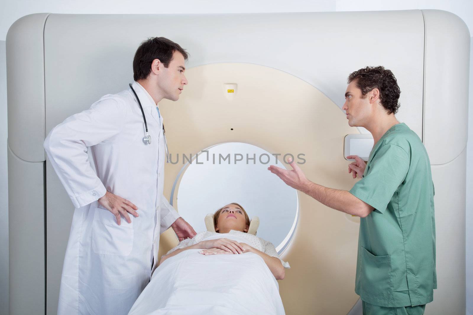 A doctor and technician discussing a CT scan