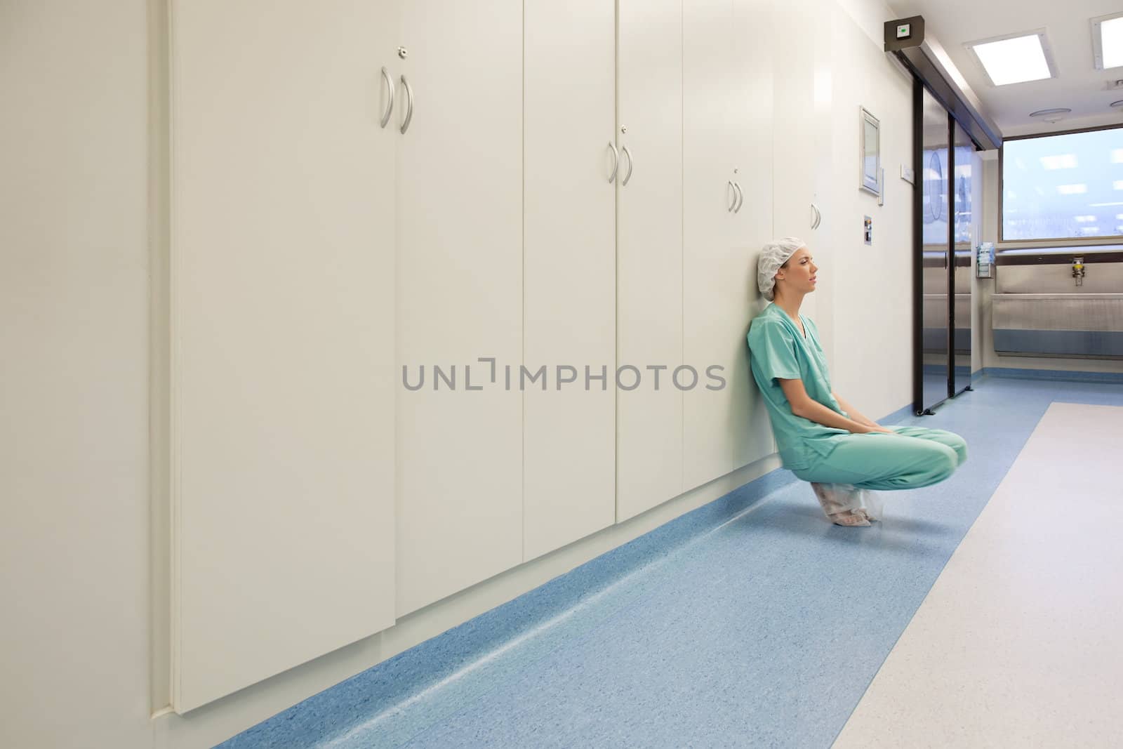 Young tired female surgeon by leaf