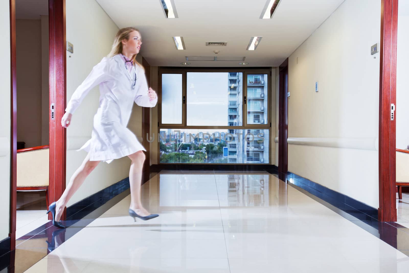 Female doctor rushing in hallway by leaf